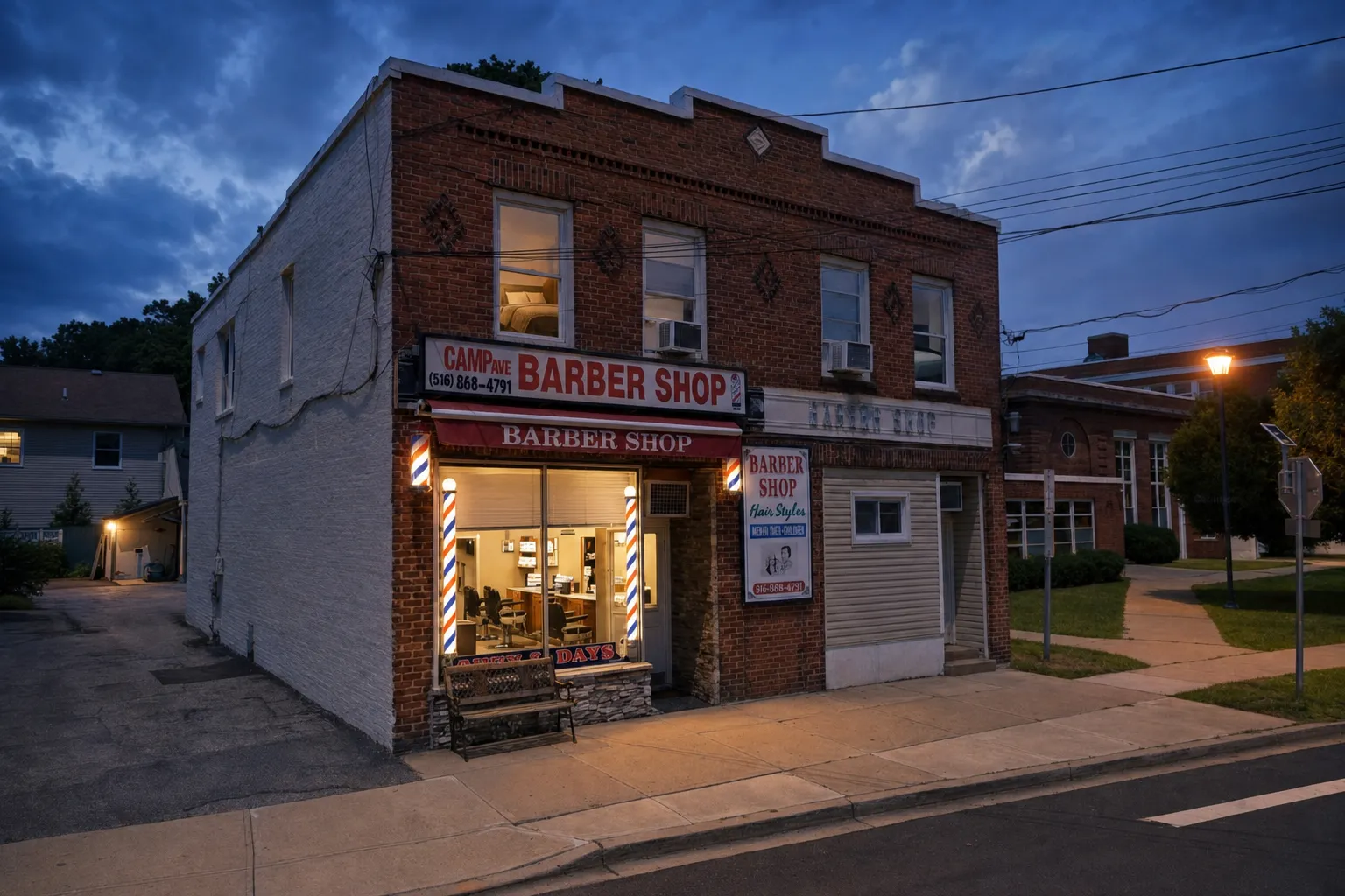 Camp Ave Barbershop storefront at dusk with windows glowing